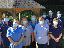 Team of brilliant nurses standing in front of a gazebo on a sunny day. GSF Quality Hallmark Awarded to Tower Ward Team
