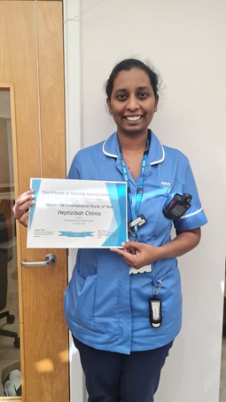 Photo of nurse Hephzibah Chinta holding her 'International Nurse of the Year' certificate