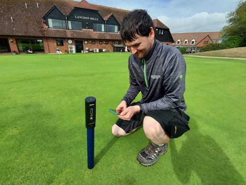 Alex Rider measuring the condition of the golf course at Langdon Hills Golf and Country Club